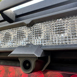 close up of wolfbox camera mounted to diode dynamics chase light bar on camper from the right